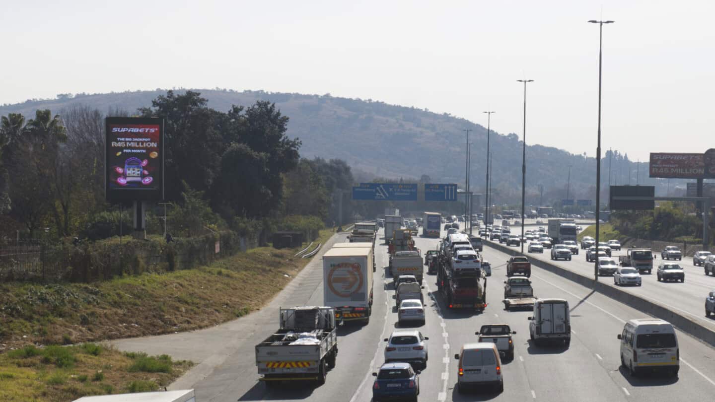 busy freeway with billboard on the side of the road